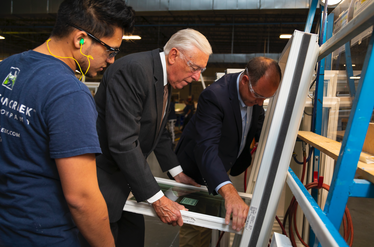 Congressman Steny Hoyer works on a window today at the Thompson Creek Window Company factory.