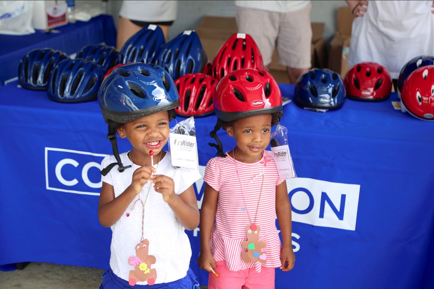 Each child was fitted with a helmet and received a bicycle safety-themed goodie bag with crayons and coloring books.