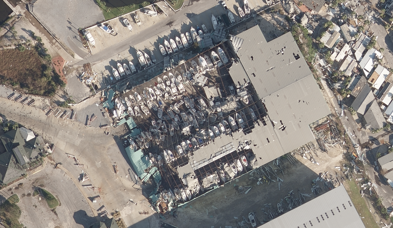 GIC ultra-high resolution vertical imagery reveals severe damage to ships and ship storage buildings in Panama City Beach, Fla. following Hurricane Michael.