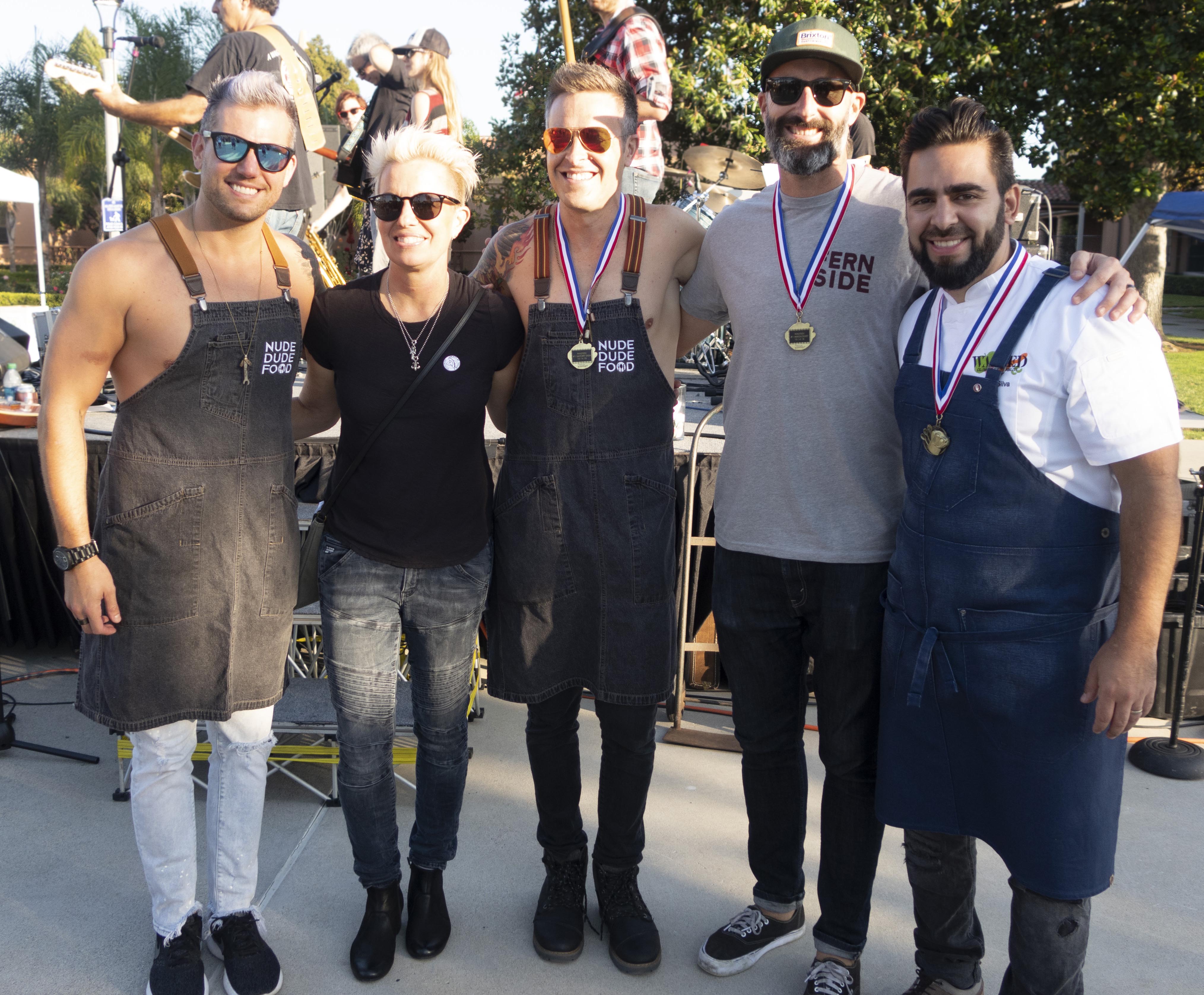 Wasted winners Nude Dude Food (Seth Bradley and Ryan Van Voorhis), Christian Siglin and Thiago Silva pose with emcee Elizabeth Falkner at WASTED in San Diego on Oct. 14.