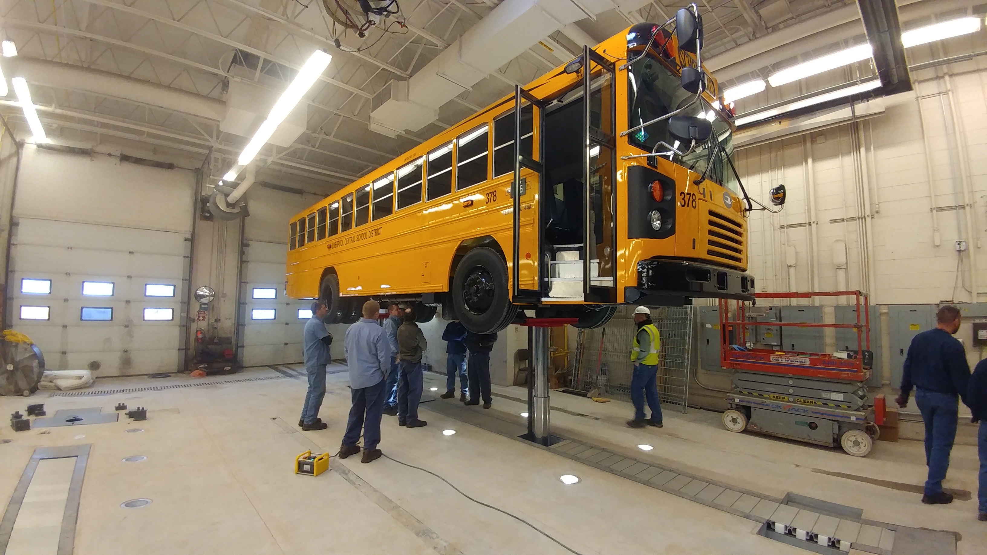 Complete access to the vehicle enables safe and efficient service and maintenance. Here, technicians inspect a school bus on Stertil-Koni's high-pressure telescopic piston lift, the DIAMONDLIFT.