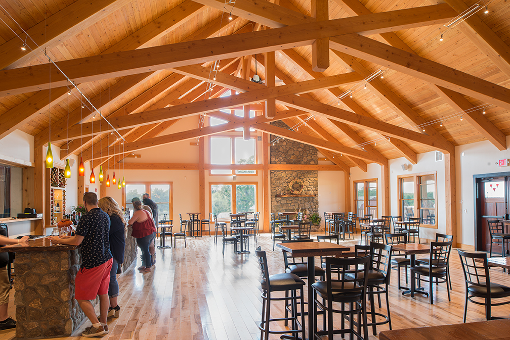 Timber frame truss roof systems and full frames from New Energy Works allow for larger open expanses that are well suited to commercial/public gathering spaces.