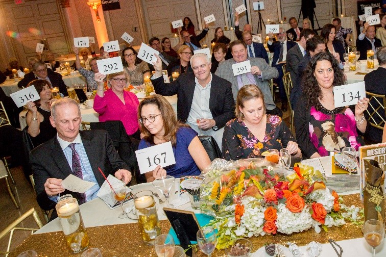 The Arc Westchester supporters during the live paddle raise at “A Matter of Taste” on October 16 at the Glen Island Harbour Club. (Photo by: Eric Vitale Photography)