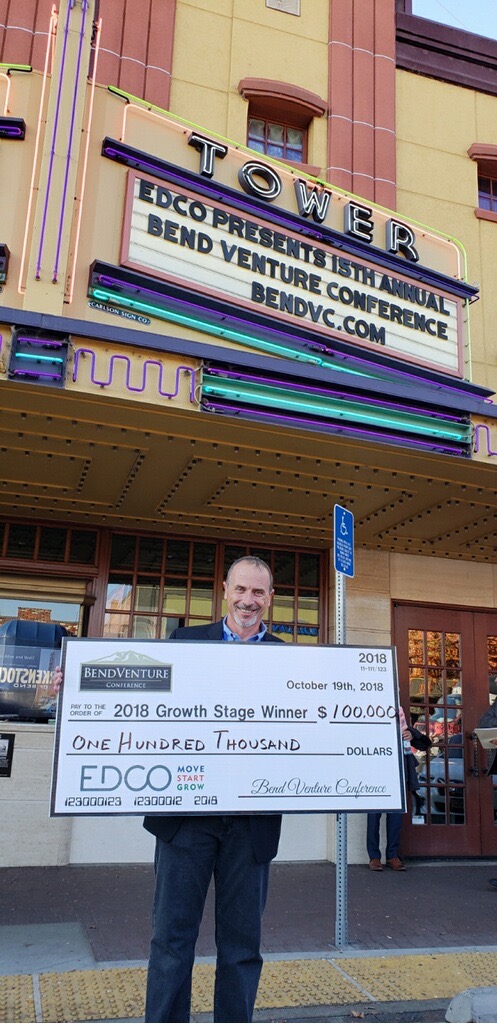 Mitch Ginsberg, CEO CommLoan stands outside the Bend Venture Conference with the big $100,000 check