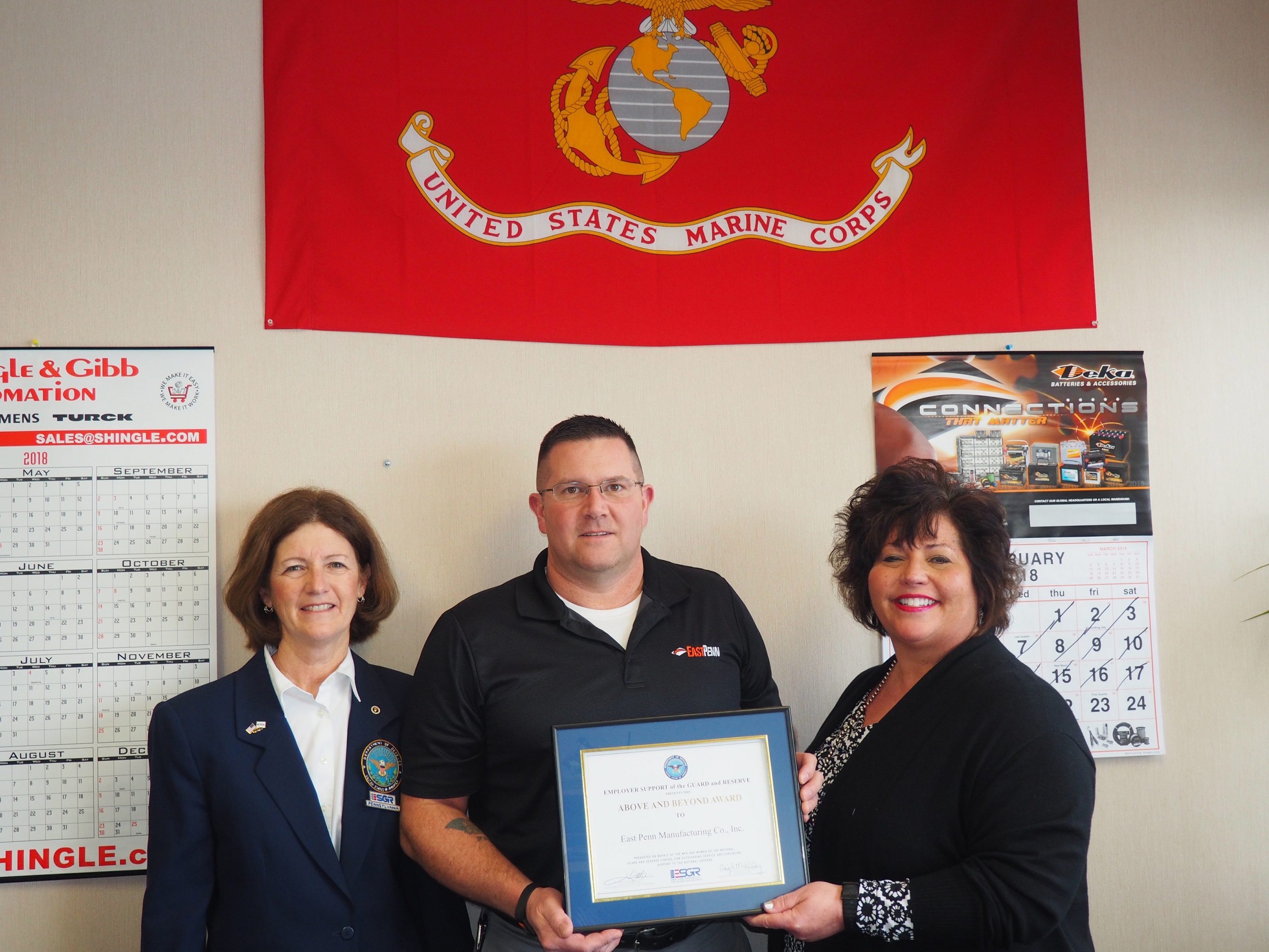 Roslyn Schroeder, ESGR representative present East Penn’s Barry Frain and Alison Snyder with the Above and Beyond Award.