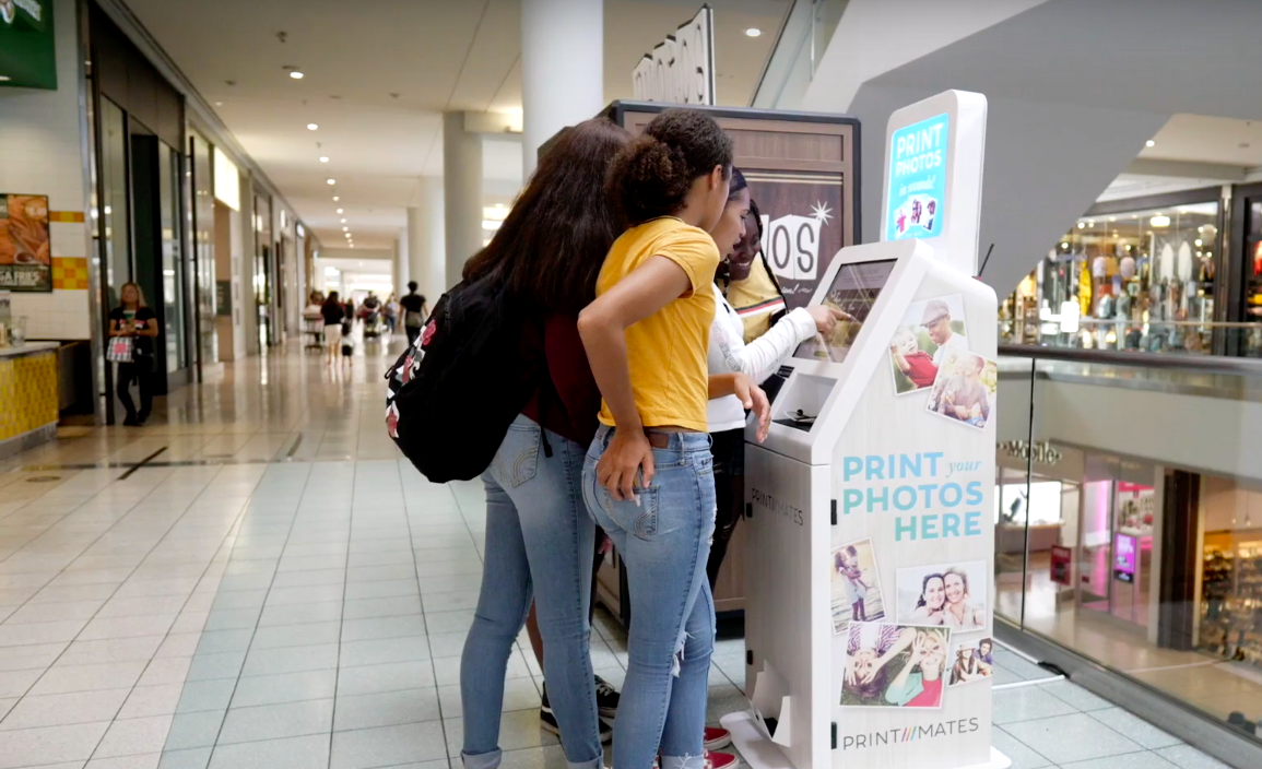 Teens Using the Print Mates Kiosk