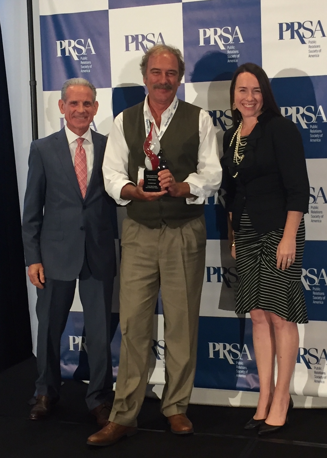 PRmediaNow Account Director Ron Whittington (center) accepts the PRSA Sunshine District Radiance Award for Media Relations Tactics for the PR firm's work on the X Suit Crowdfunding Campaign.