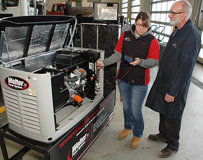 Image: Gateway student Rae Schielie trains on a generator with Diesel Technology instructor Joe Palacek.