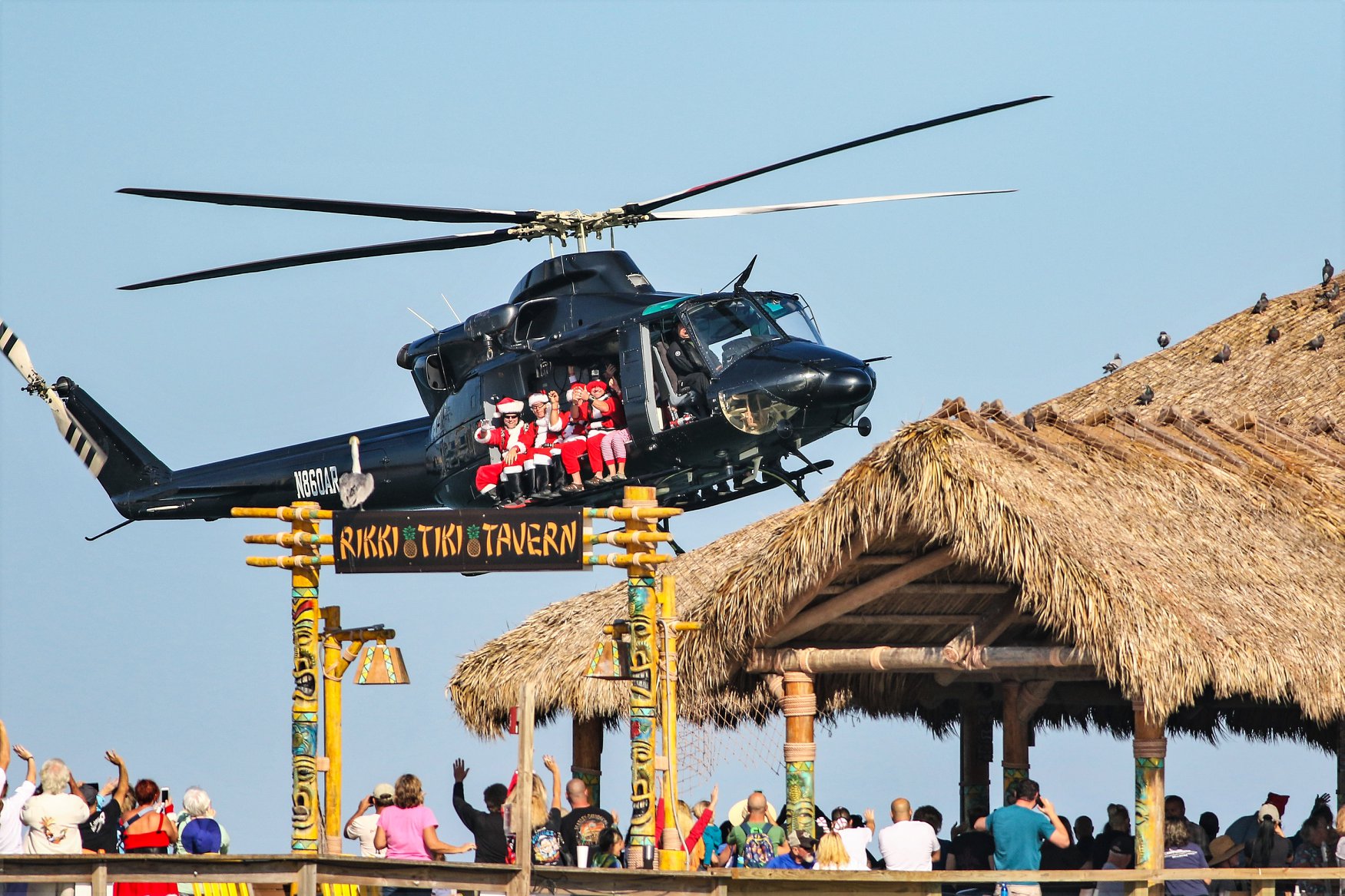 Skydiving Santas of Cocoa Beach fly over Cocoa Beach Pier