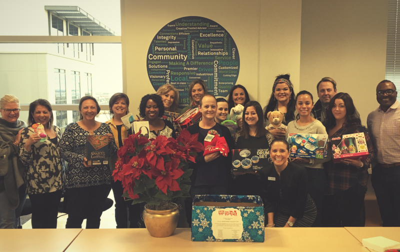 FirstService Residential associates at the Fort Worth office showing off their Toys for Tots.
