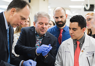 Tony Nobles demonstrates how one of his products works during a visit to Liberty University College of Osteopathic Medicine in October 2018.