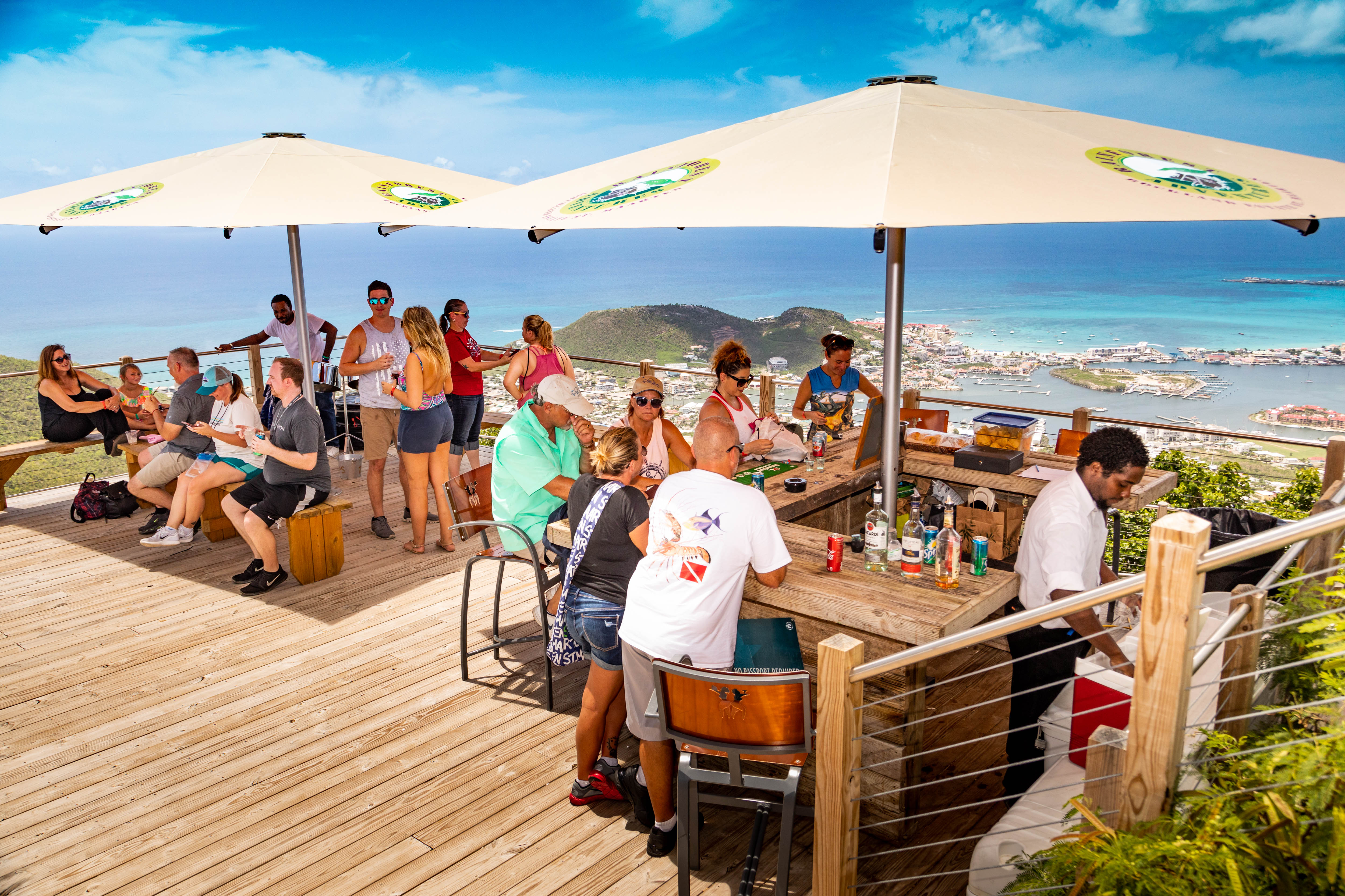 Guests linger for the views at Rainforest Adventures Rockland Estate's hill-top bar in St. Maarten.