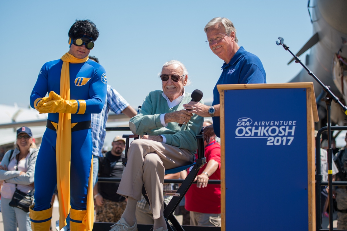 Marvel Comics legend Stan Lee (center), introduces his new superhero, Aviore (left), at EAA AirVenture Oshkosh 2017 on July 28, 2017. At right is EAA CEO/Chairman Jack Pelton.