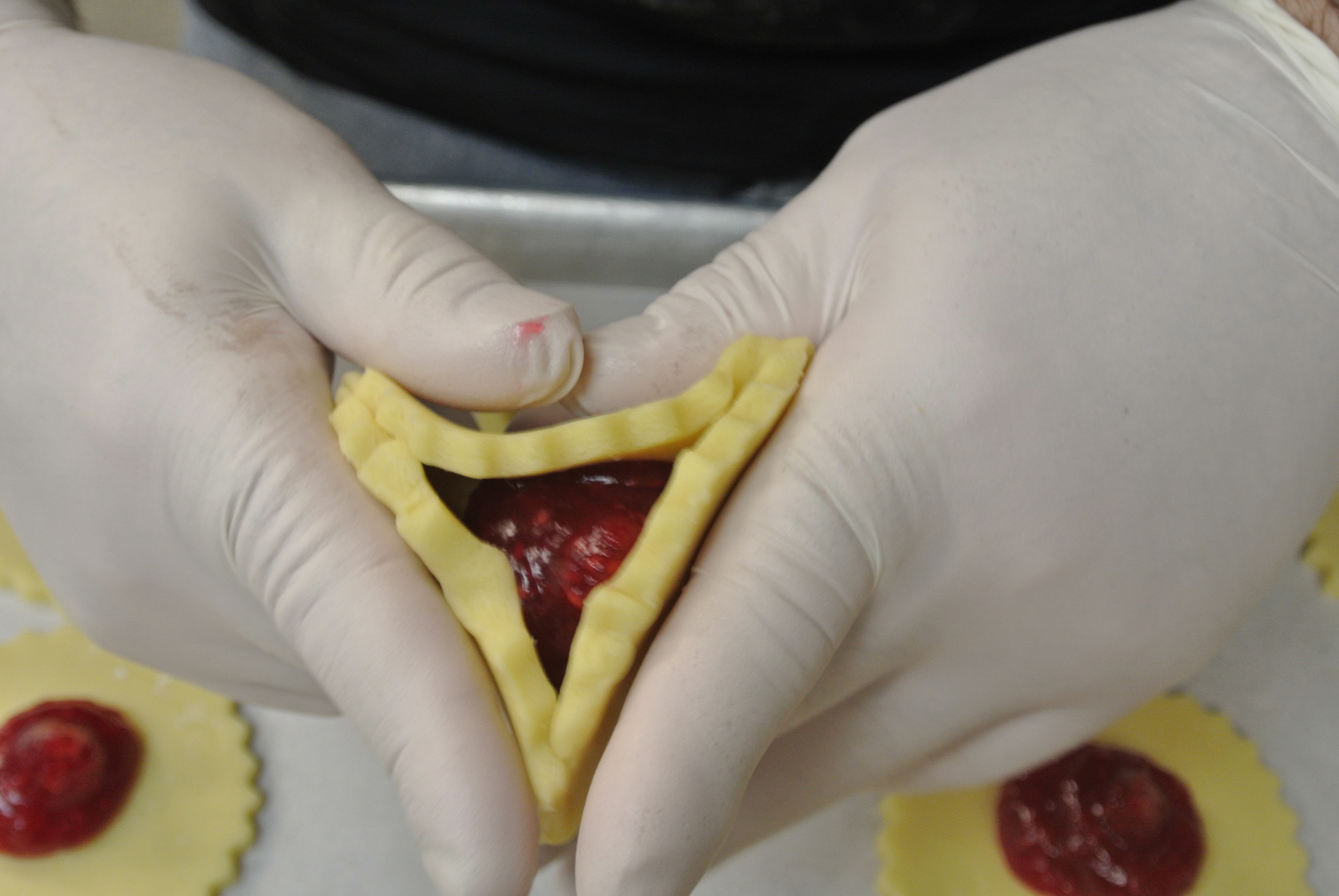 Three Brothers Bakery form Hamentaschen into a triangular filled cookie