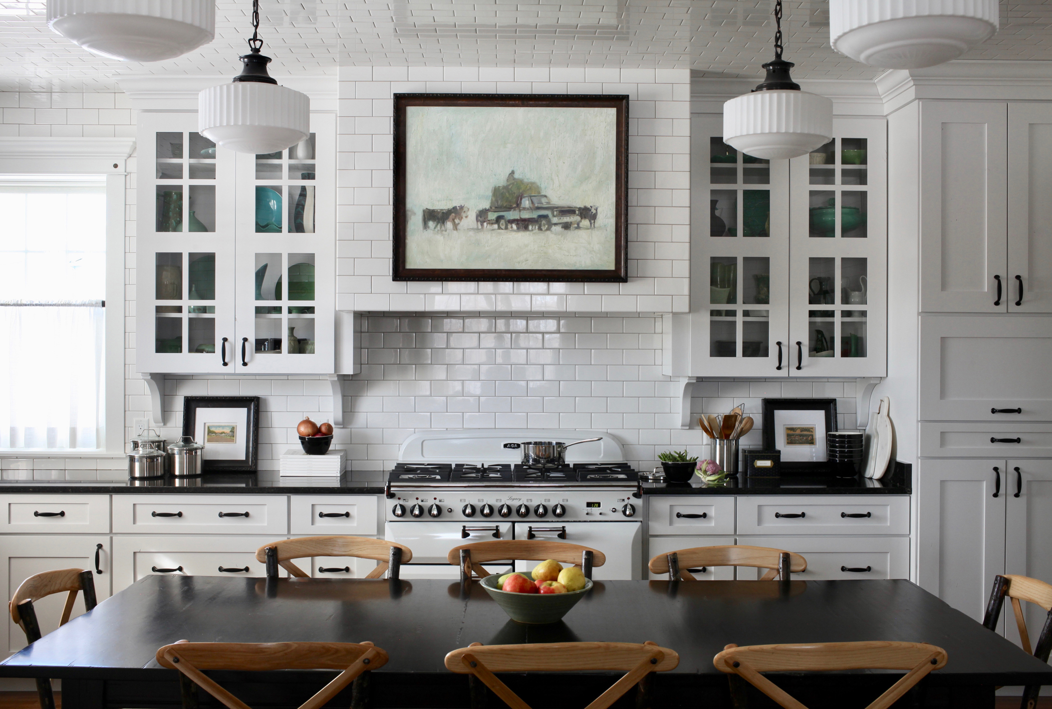 Jeremiah Young of Kibler & Kirch, embraced farmhouse style in his own small kitchen, splurging on extending white subway tile onto the ceiling. The range is an Aga Legacy.