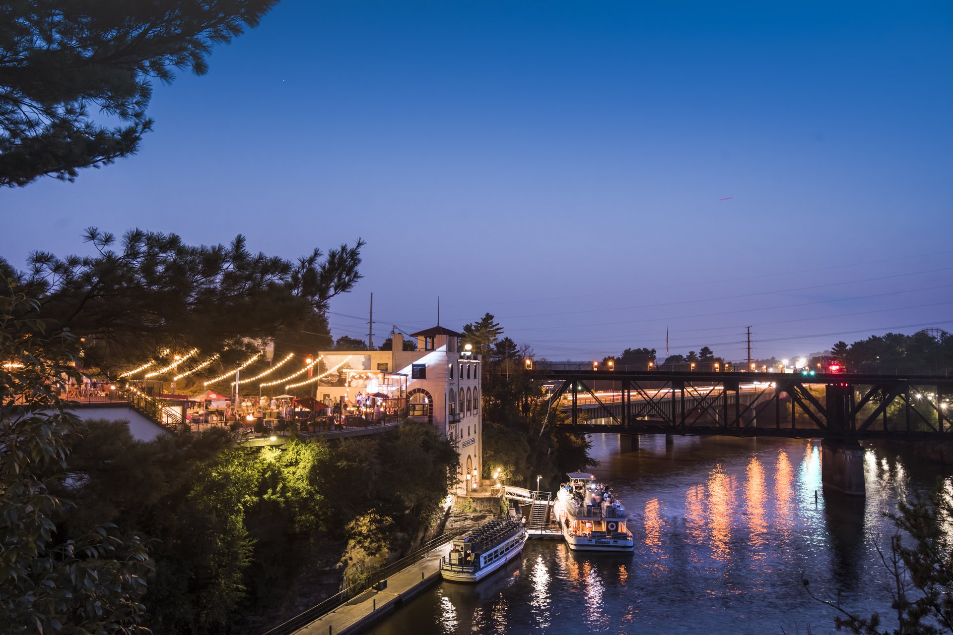 The Wisconsin Dells riverfront shines brightly during the evening hours.