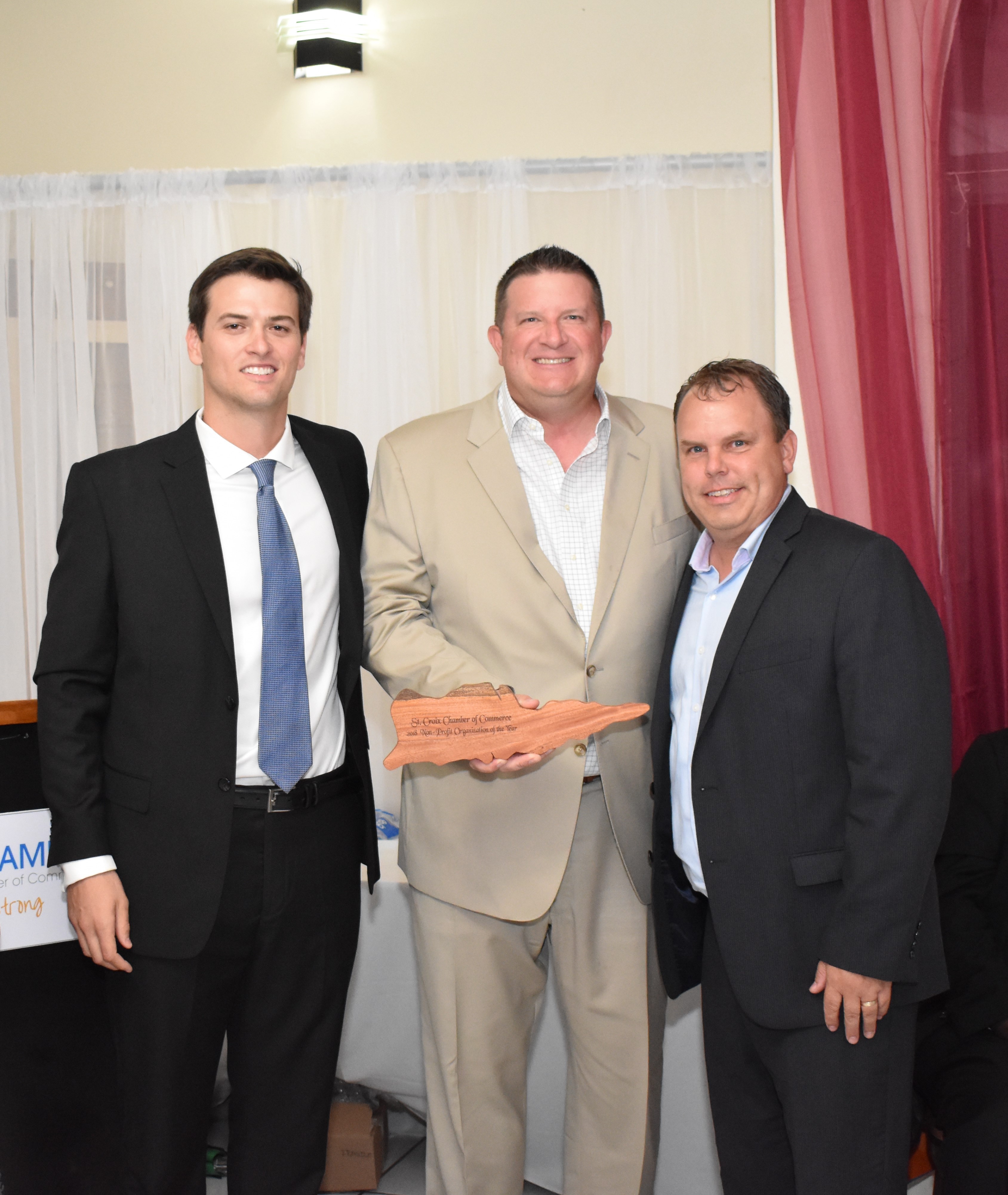 St. Croix Chamber of Commerce President Ryan Nelthropp presents the Nonprofit of the Year Award to David Johnson and Kirk Chewning.