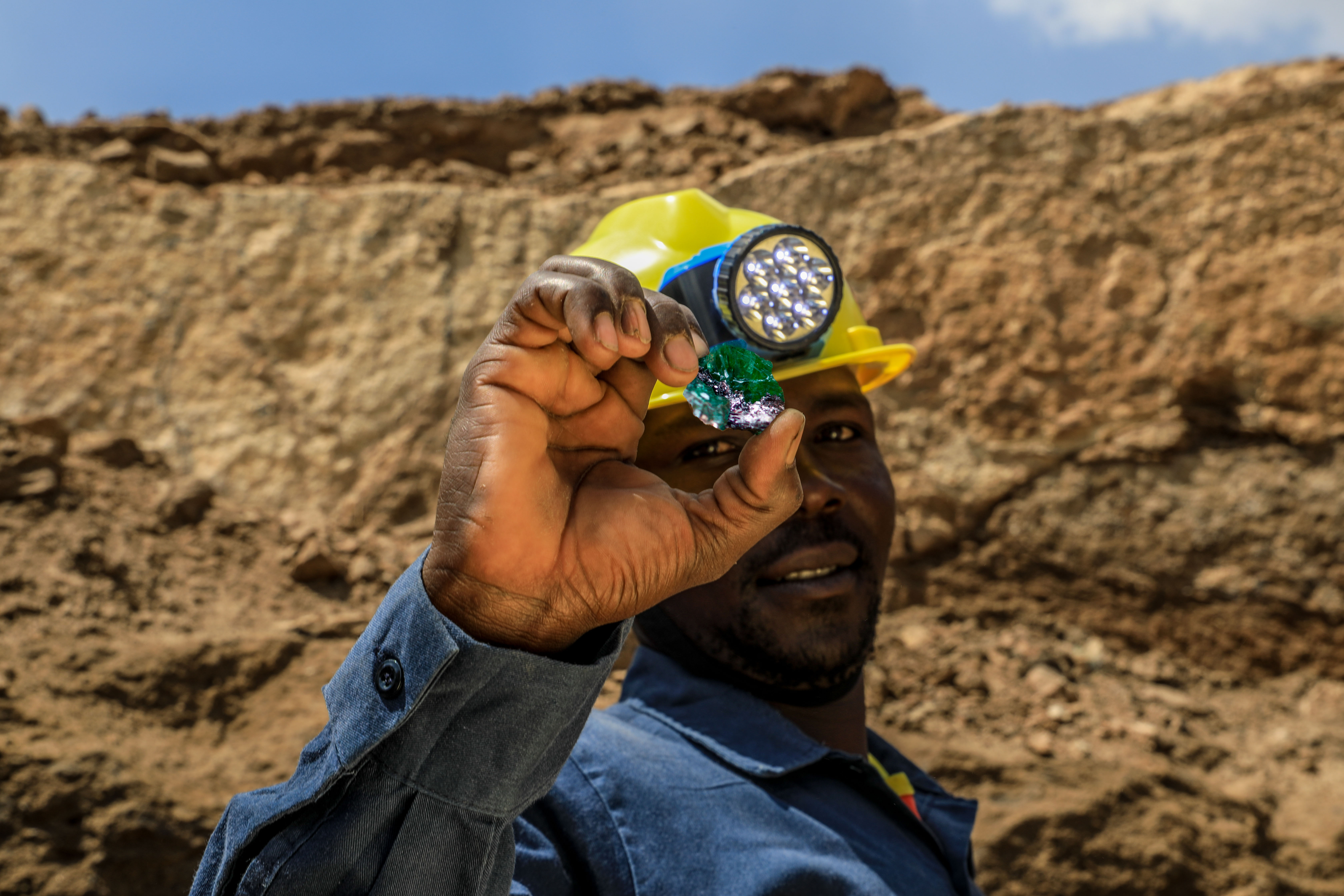 An artisanal miner holding rough Tsavorite from Tanzania