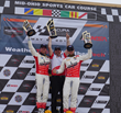Kyle Marcelli, Dean Martin (team owner), and Nate Stacy on top of the podium at Mid-Ohio.