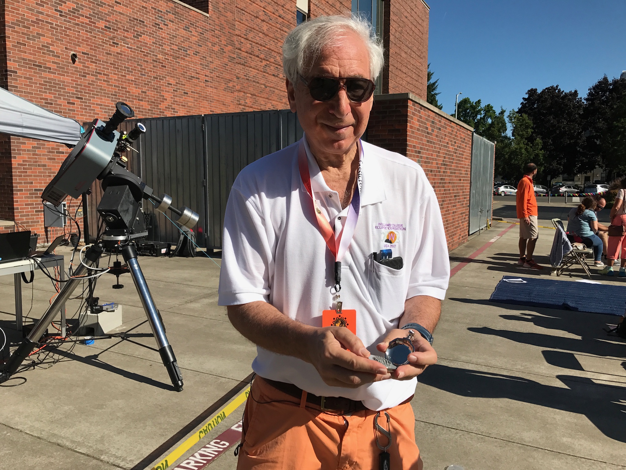 Es6eemed Astronomer Jay Pasachoff  holding Stonehenge Watch at The Great American Eclipse, in Salem, Oregon
