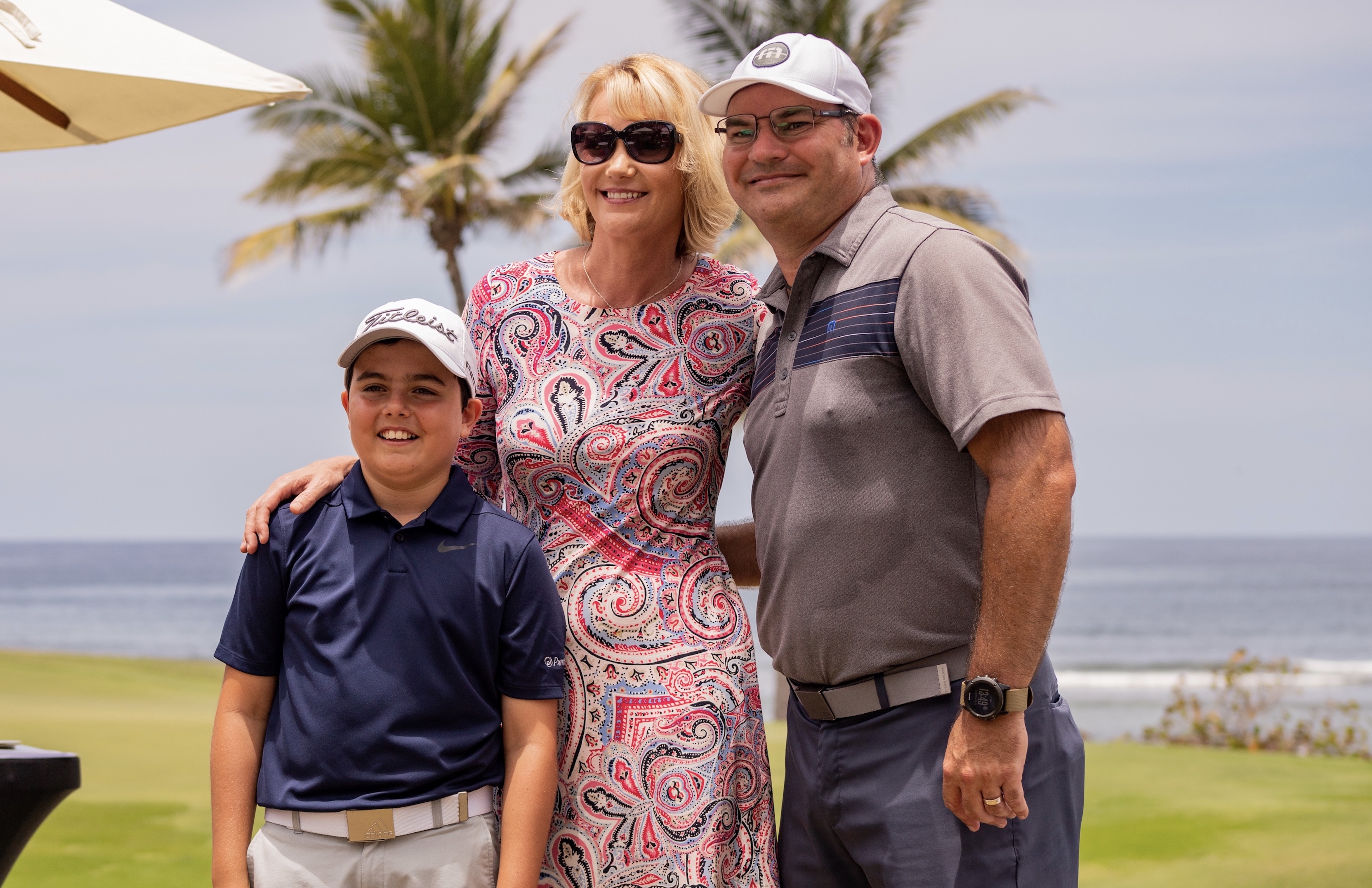 Diana DeLucia of Golf Kitchen Magazine congratulates father and son winners of the tournament, Ricardo Trueba and son, eleven year old sensation Ricardo Trueba Jr.