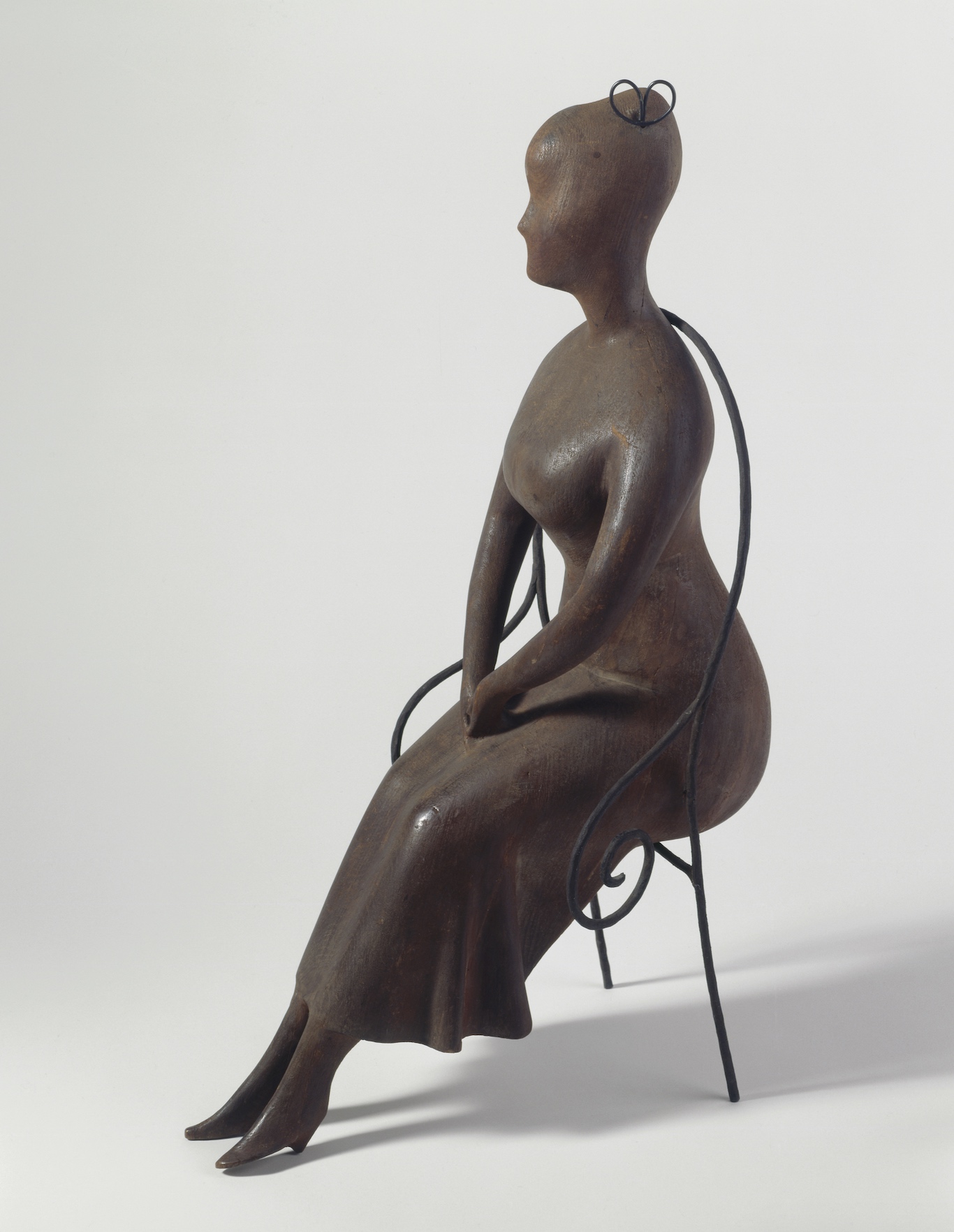 Elie Nadelman, Seated Woman, 1919-25. Cherry wood and iron. Addison Gallery of American Art, Museum purchase Artwork © Estate of Elie Nadelman; photograph, Greg Heins.