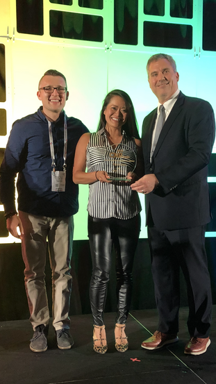 Trulioo's VP of Growth, Anatoly Kvitnitsky (left) and VP of Marketing, Kim Hong, accept the award from John Bomier, Event and Community Director of CardNotPresent.com and the CNP Expo.