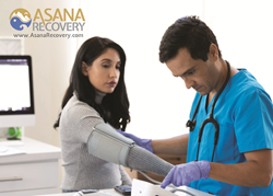 Asana Recovery nurse monitors patient and takes blood pressure for addiction treatment