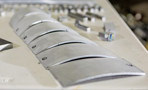 Laser peen forming shapes these aluminum samples at a variety of precise curves and radii.