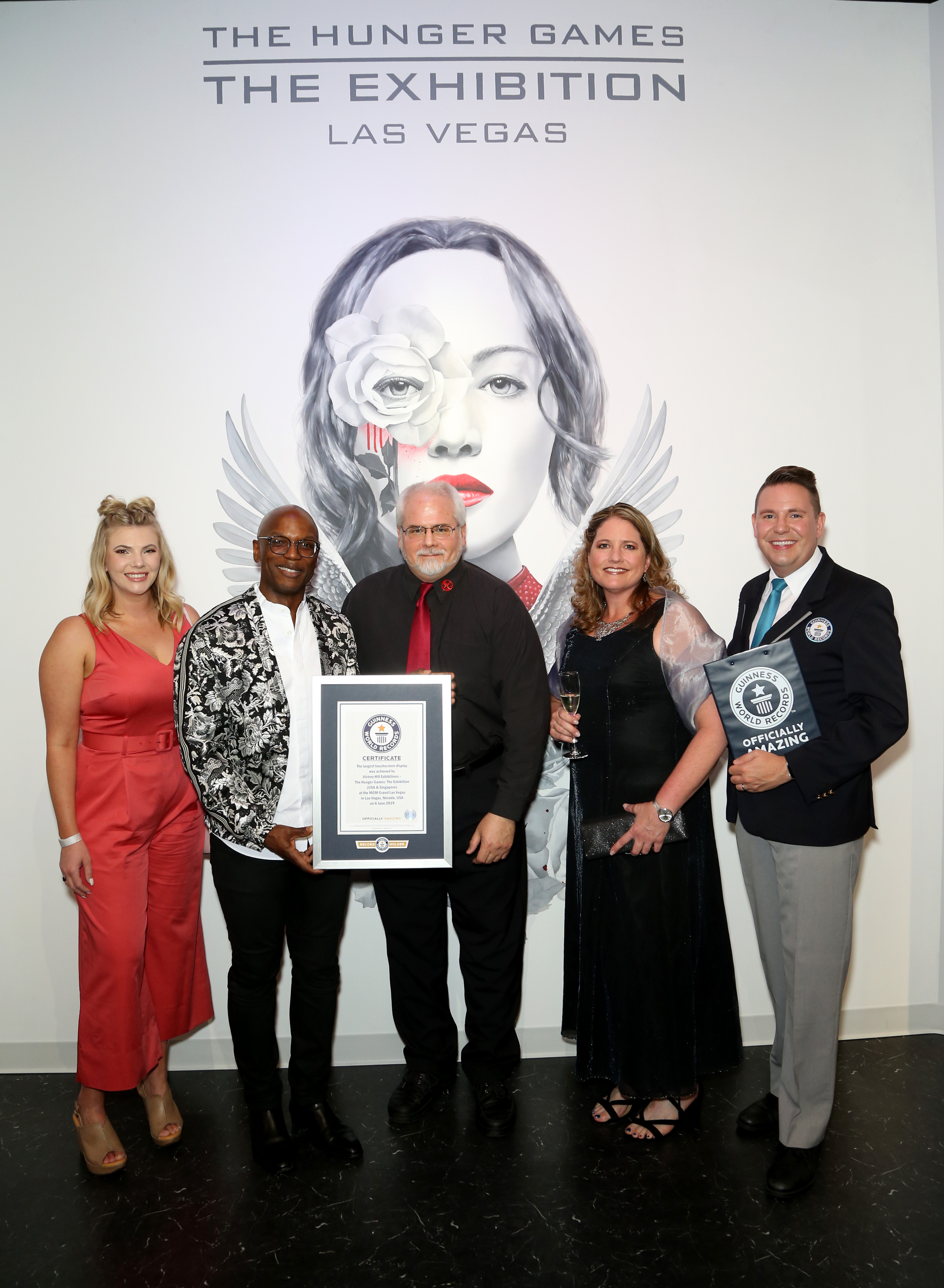 The Hunger Games: The Exhibition's creative team (L to R), Jessica Marchant, Welby Altidor, Scott Stevens and Nicole Abram pose with judge Michael Embric of Guinness World Records.