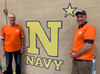 Scott and Former Navy Lt. Jay Smalling next to Navy Symbol they painted in Gymnasium.  All other branches of US Military were also honored in paintings.