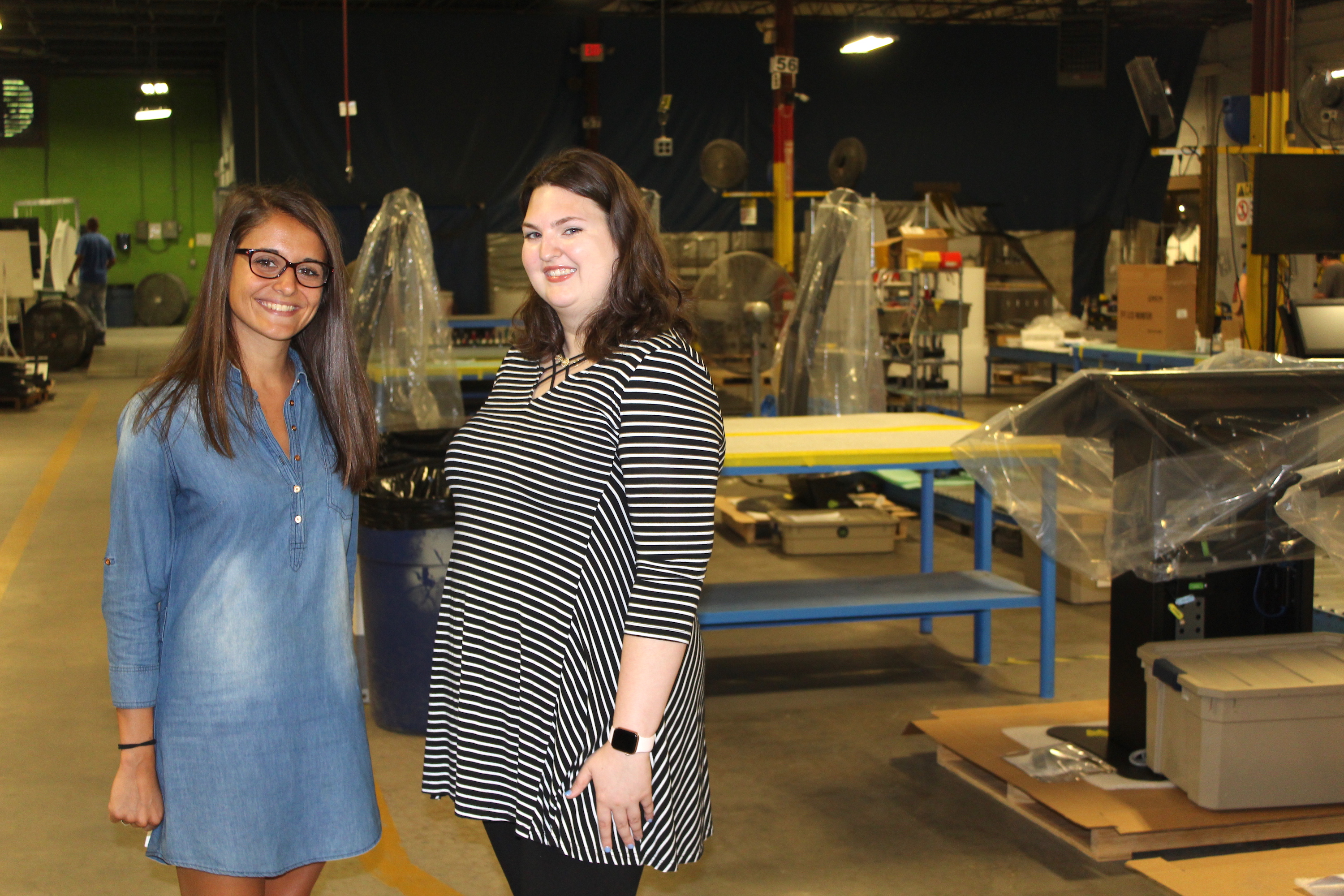 Melissa Tally, Meridian's Marketing Coordinator, and Lily Blake tour the Meridian assembly floor.