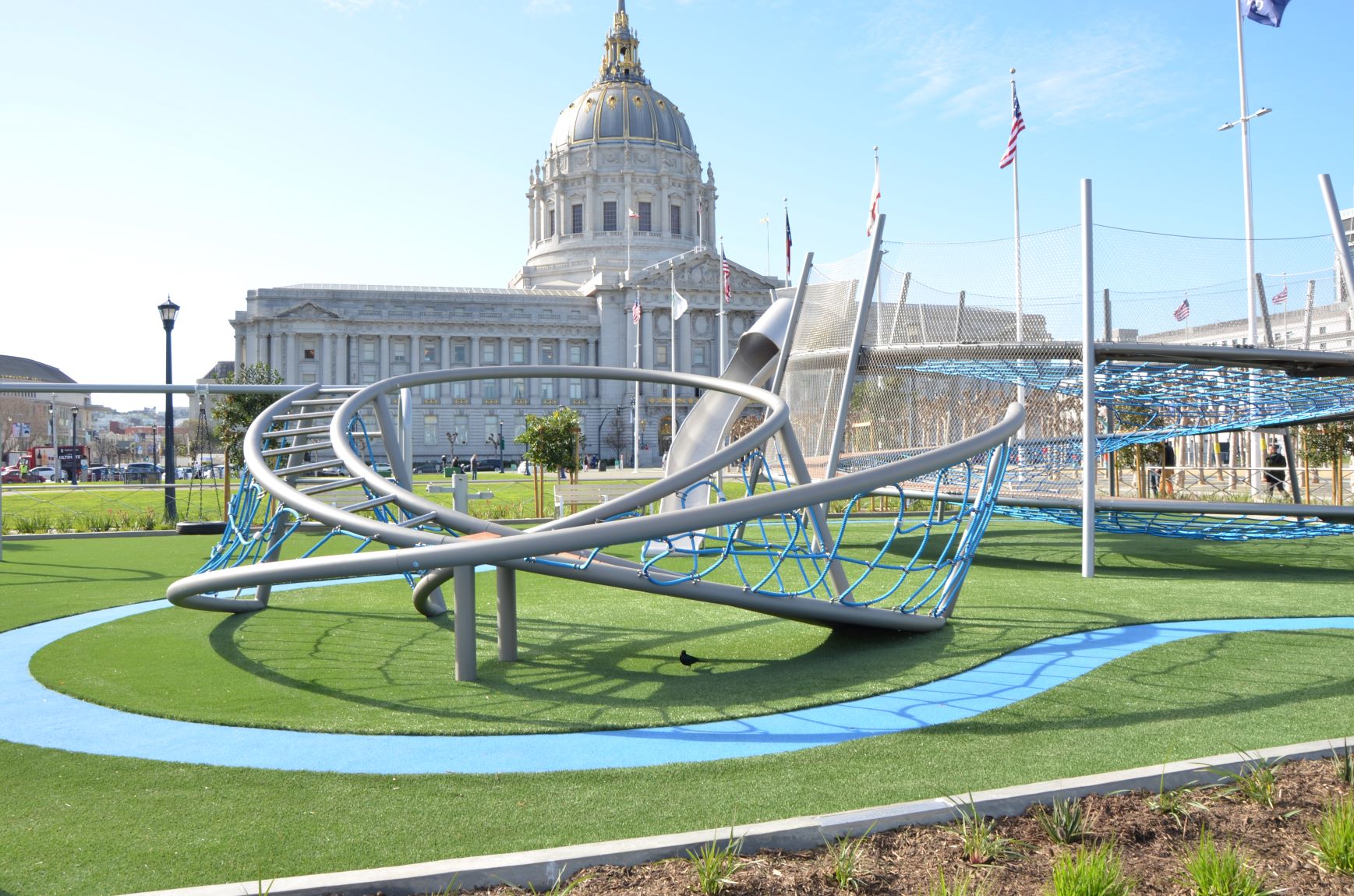 Award Wining Helen Diller Playground rises in front of San Franciso City Hall