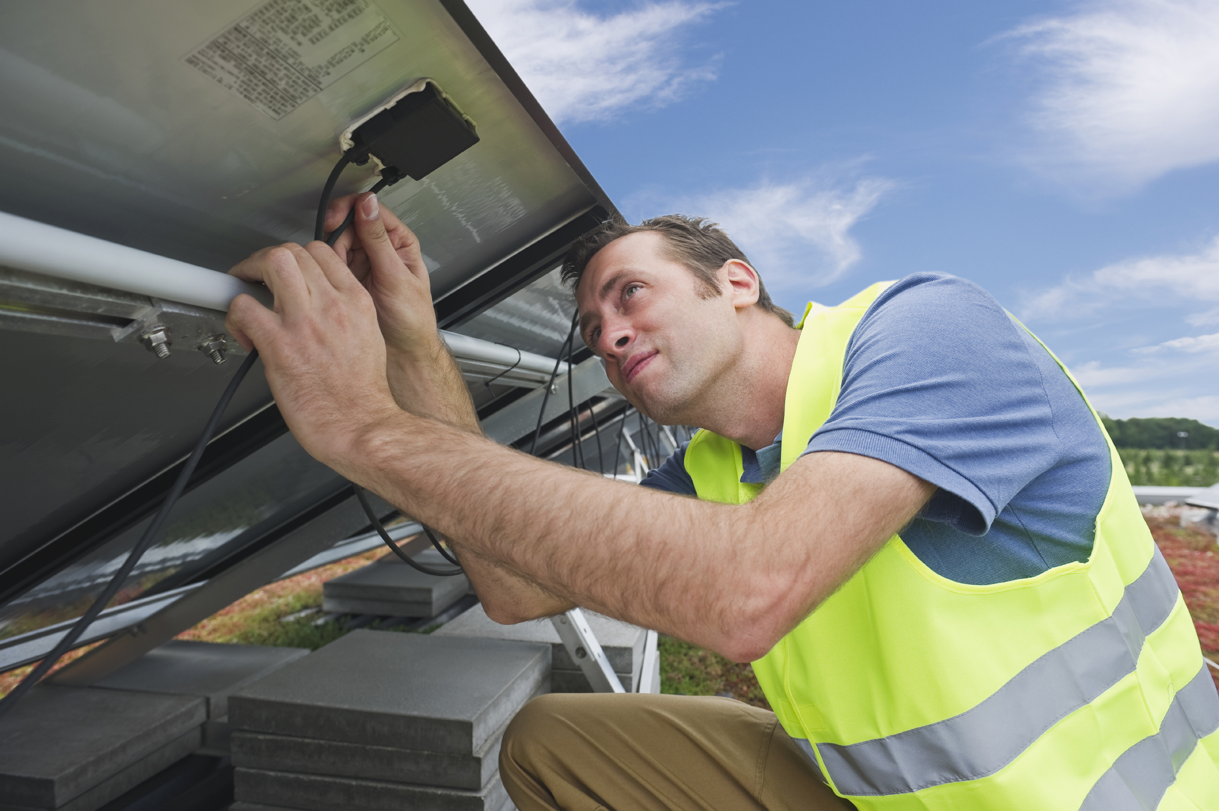 Solar Technician Examining PV Panel