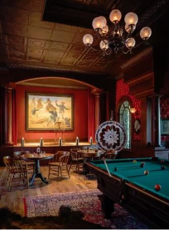 Kibler & Kirch helped create an in-home Wild West saloon featuring a curtained stage and Brunswick pool table for this special Wyoming home (photo by Audrey Hall).