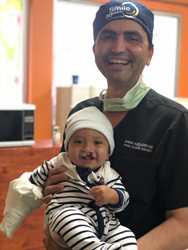 Dr. Babak Azizzadeh and a child with a cleft palate