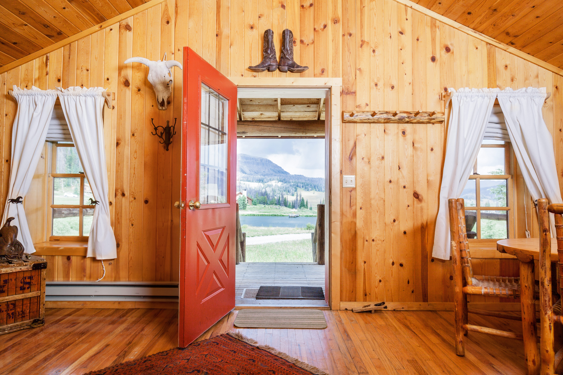 Guests of Brooks Lake Lodge enjoy the scenic lakeside setting along with cozy lodge rooms and cabins for a quiet restful night sleep amid stunning scenery.