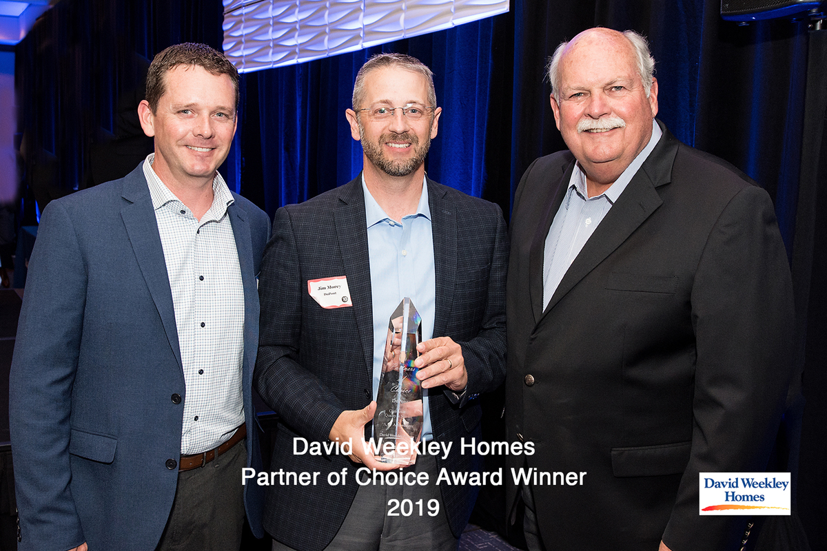 For DuPont™ Tyvek®, from left: Ben Weise, David Weekley Homes, Sarasota Div. Purchase Manager; Jim Morey, DuPont Performance Building Solutions US Sales Leader; David Weekley, Chairman