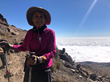 Anne stands above the clouds at 14,000 feet. Photo by Dan Gluck.