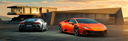 Gray and Orange 2019 Lamborghini Huracán EVO Models in a Driveway at Sunset