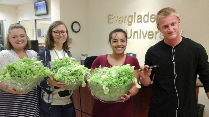 Students display lettuce grown in AquaGrove
