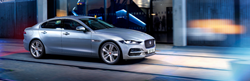 Silver 2020 Jaguar XE on a City Street at Night