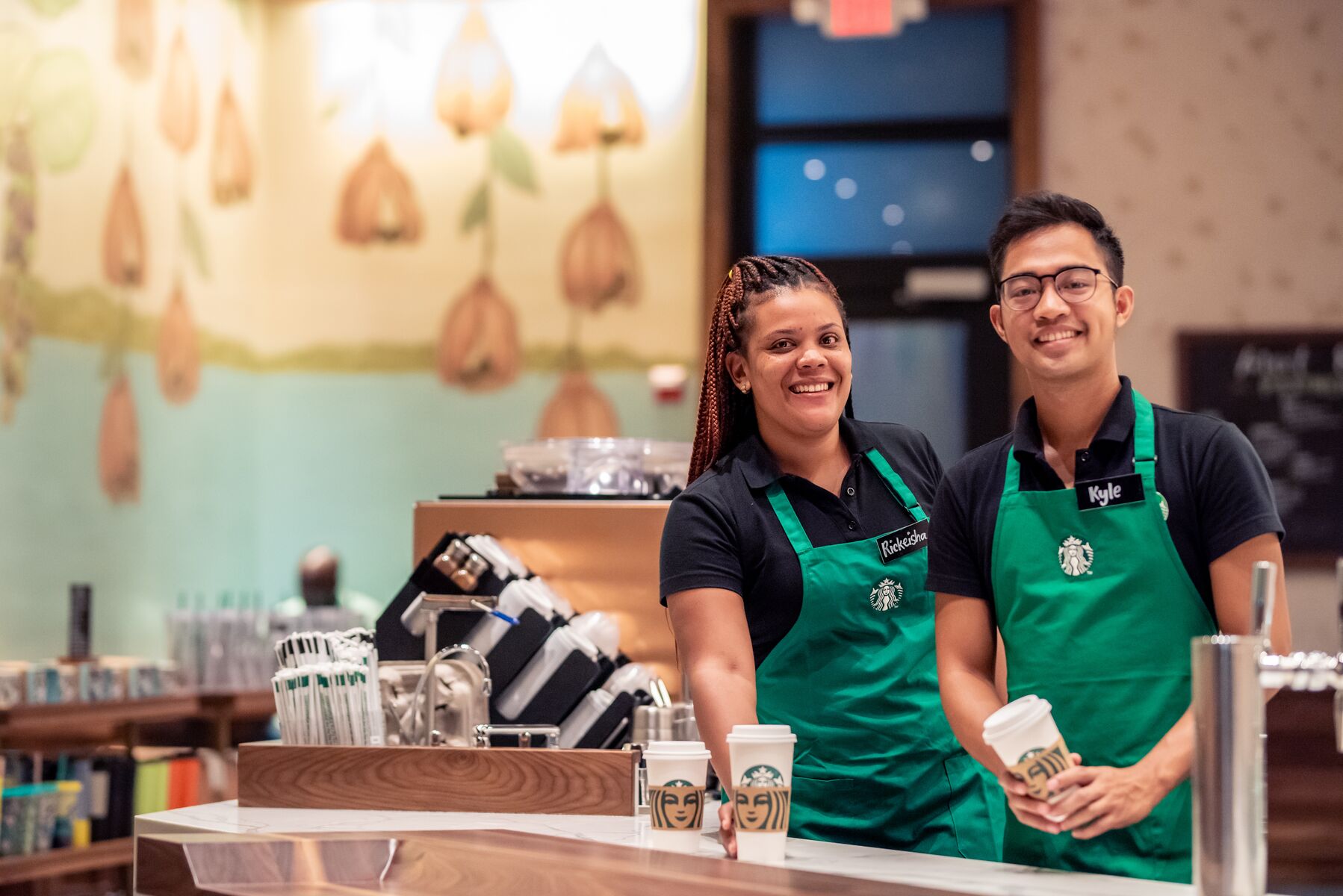 Team members Rickeisha and Kyle in the newly opened Starbucks café in Camana Bay, the first Cayman Islands location for the global coffeehouse.
