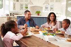 Family around the dinner table enjoying the benefits of eating as a family.