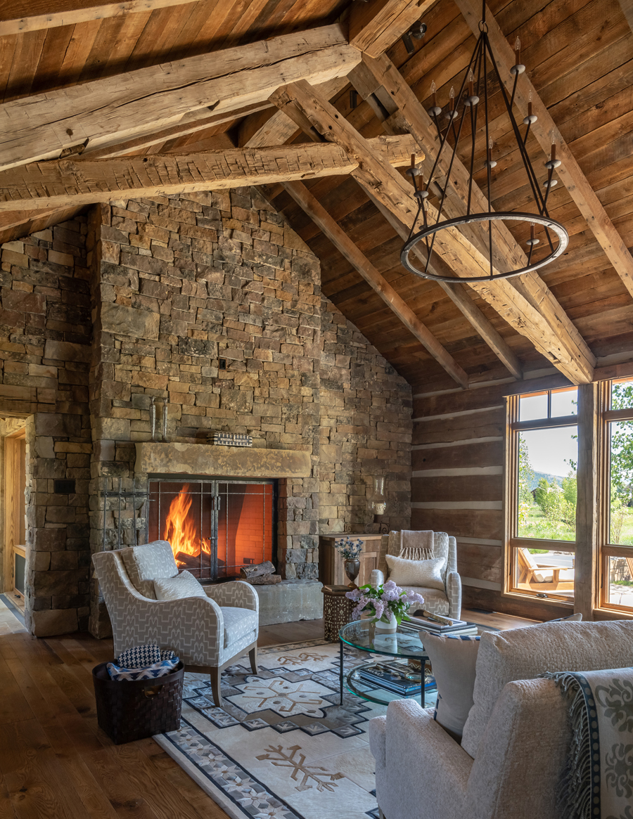 A Jackson Hole house featuring dramatic scissor trusses of reclaimed wood that create a powerful architectural moment is one of three JLF Architects-designed homes in “Cabin Style.”