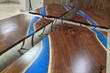 A Detroit sports car club wanted an all-purpose river table that could be separated into four tables. They are made with walnut live edge slabs and blue epoxy resin.