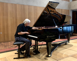 Dennis Johnson, lead piano technician at St. Olaf College, carefully tunes the college's new Bösendorfer 280VC Vienna Concert grand piano.