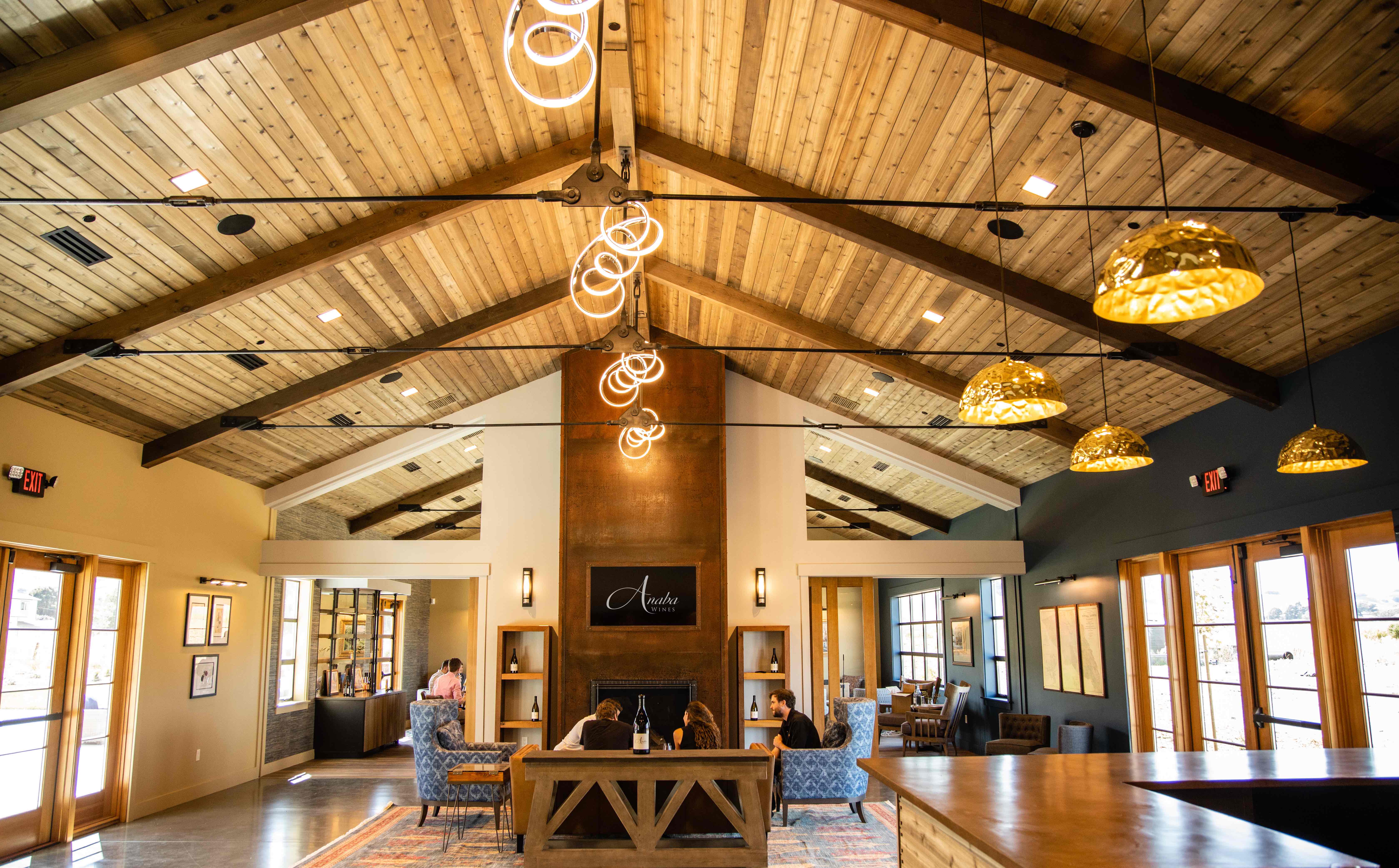 The thoughtful space includes a long communal table and bar for casual tastings, as well as a light-filled room with cozy, intimate seating areas for in-depth wine education.