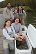 Biologists from the Tennessee Aquarium Conservation Institute acclimate baby Lake Sturgeon for release at Kingston, TN. Clockwise from top left: Ayi Ajavon - Conservation Volunteer, Anna Quintrell - Reintroduction Assistant, Dr. Anna George - VP of Conservation Science and Education, Avery Millard – Aquarist I , Meredith Harris – Reintroduction Biologist.