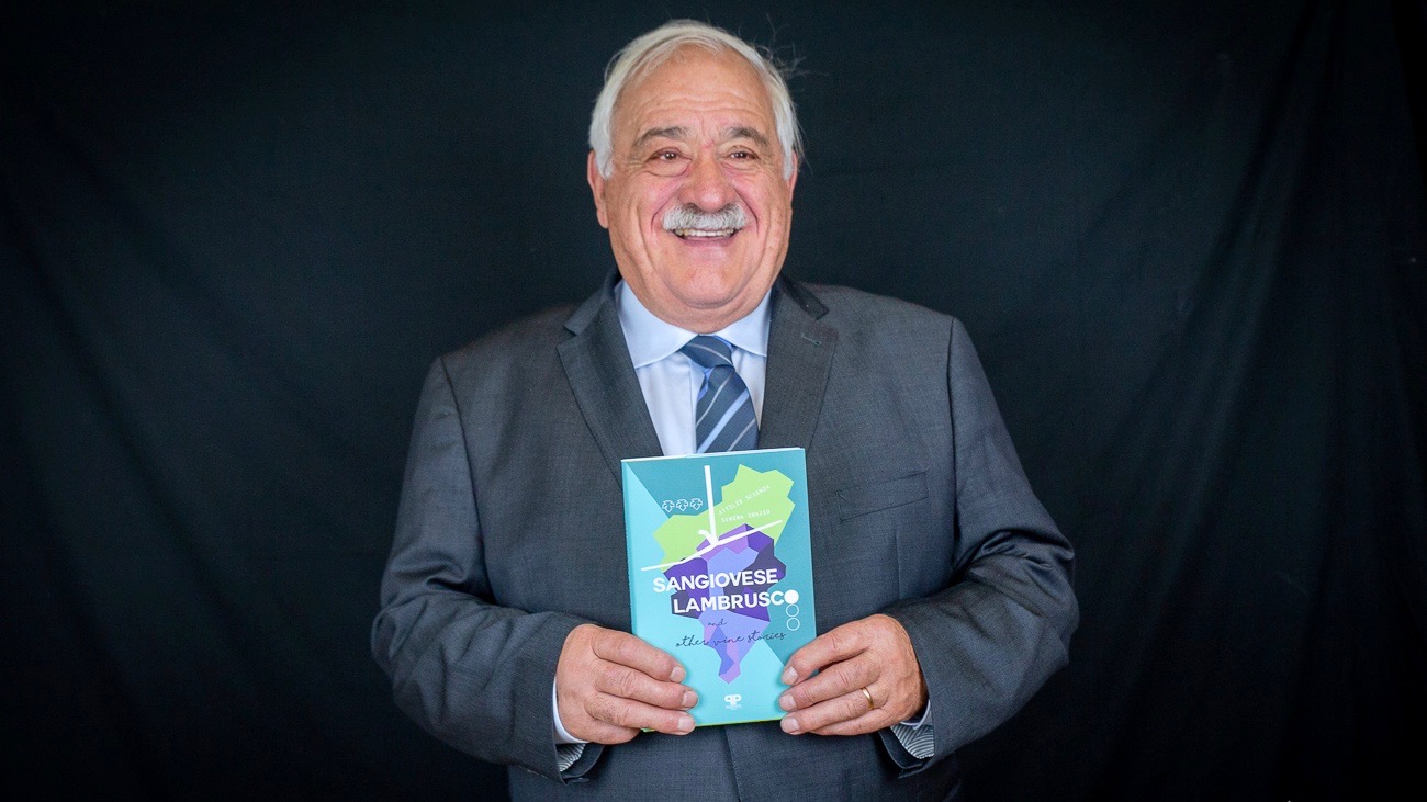Co-author Attilio Scienza poses with a copy of the new English translation of his latest monograph on the history of Italian and European wine.